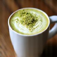 Pistachio latte with latte art in ceramic mug